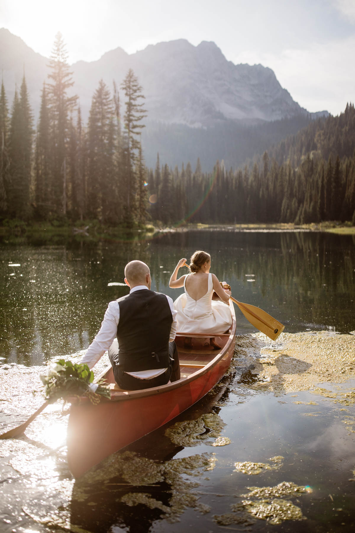 Fernie wedding photographers at Island Lake Lodge wedding canoe with bride and groom
