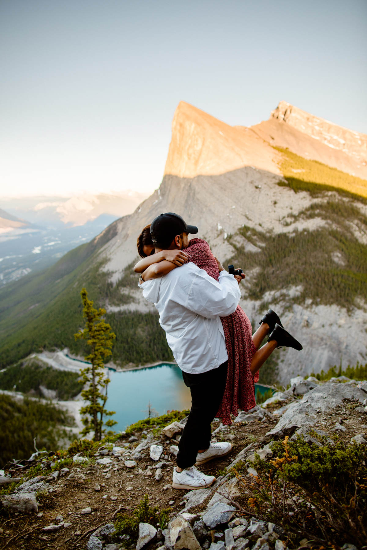 Surprise proposal photographers in Banff on East End of Rundle with views of Ha Ling hike in Canmore