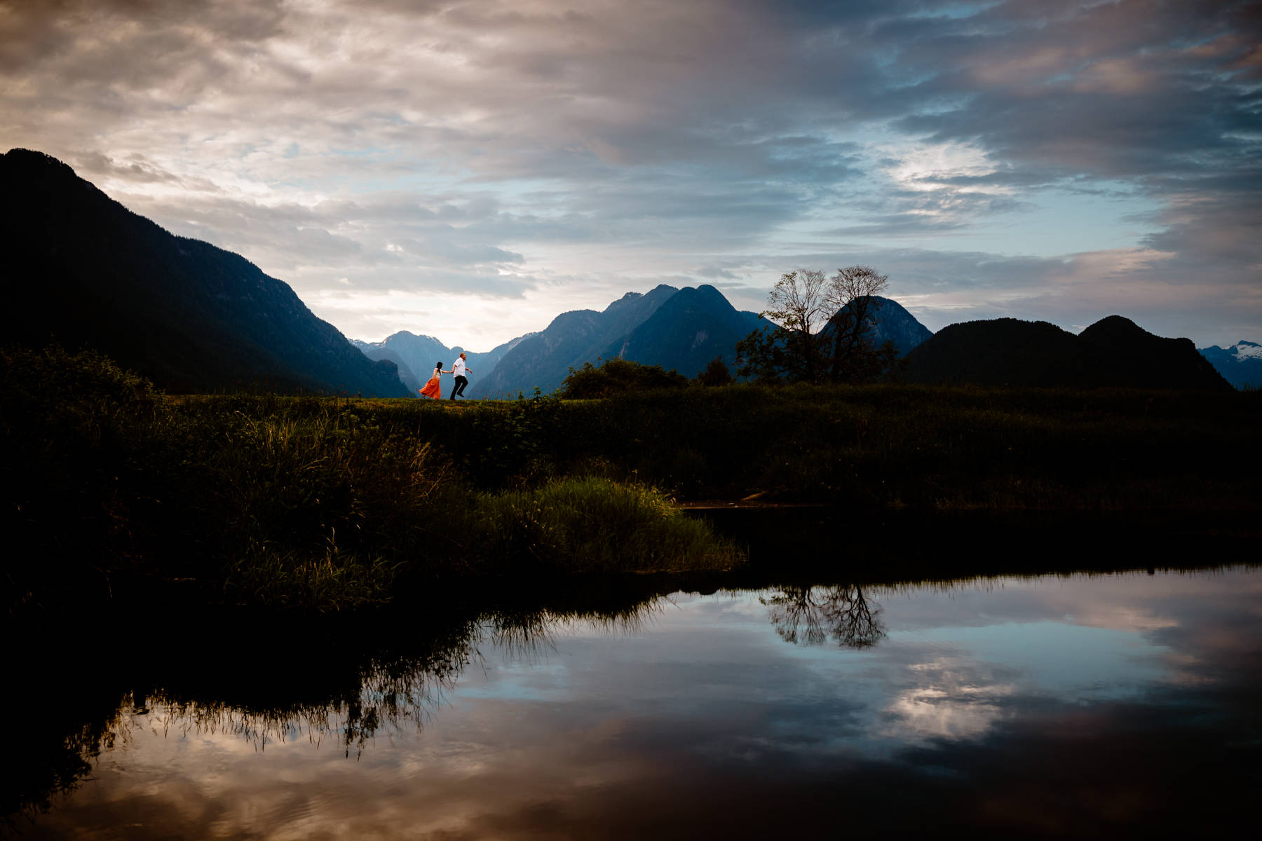 Vancouver engagement photographers at Pitt Meadows with mountain photos in May